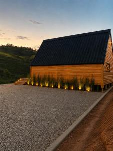 a barn with lights on the side of it at Cabana Do Luar in Serra Negra