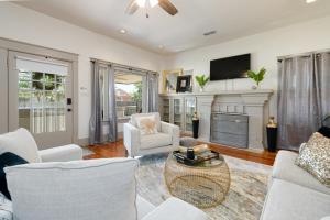 a living room with white furniture and a fireplace at Uptown Merchant in Abilene