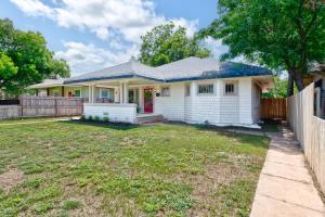 a white house with a fence and a yard at Uptown Merchant in Abilene