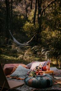 a couch with a tray of food and a table at ROSINA Beach Shack in Bellbrae
