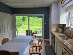 a kitchen with a table and a dining room with a view at Martin's apartment in Saguenay