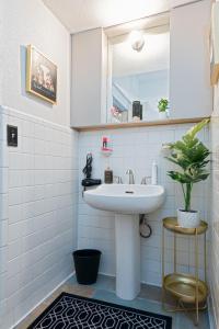 a bathroom with a sink and a mirror at Uptown Merchant in Abilene +57 photos