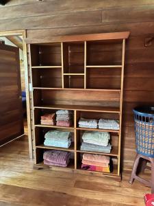 a closet with wooden shelves and towels at Kliffstone Jungle House in Sayab Camp +138 photos