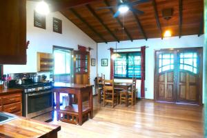 a kitchen with a table and a dining room at Kliffstone Jungle House in Sayab Camp