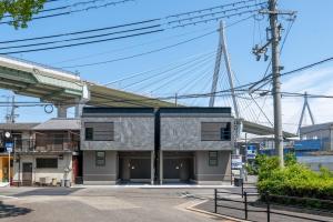 a building with a bridge in the background at Universal front villa Sanrriott in Osaka
