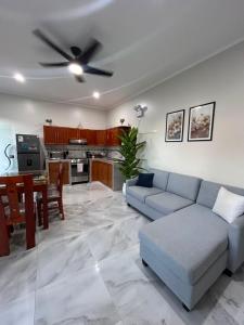 a living room with a couch and a ceiling fan at casa sol de sauce in Sauce