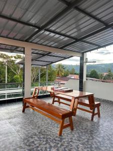 a patio with two benches and a table at casa sol de sauce in Sauce