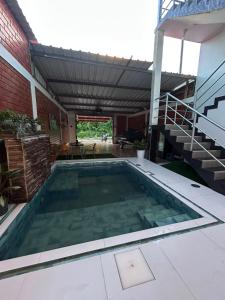 a swimming pool in the middle of a house at casa sol de sauce in Sauce