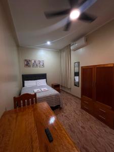 a bedroom with a bed and a wooden table at casa sol de sauce in Sauce +33 photos