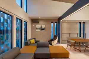 a living room with a couch and a table at Universal front villa Sanrriott in Osaka