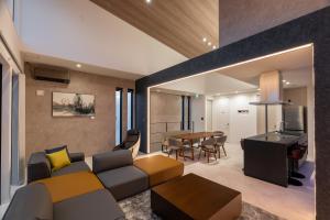 a living room with a couch and a table at Universal front villa Sanrriott in Osaka