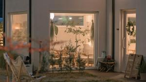 a room with a glass door with plants in it at Yangyang Stay Wabom in Yangyang