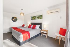 a bedroom with a large bed with red pillows at Modern-Immaculate-Spacious-Comfy Beds-Private in Westport +13 photos