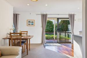 a kitchen and living room with a table and chairs at Modern-Immaculate-Spacious-Comfy Beds-Private in Westport