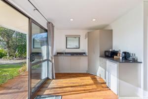 a kitchen with white cabinets and a large window at Modern-Immaculate-Spacious-Comfy Beds-Private in Westport
