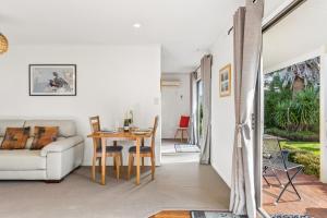 a living room with a table and a couch at Modern-Immaculate-Spacious-Comfy Beds-Private in Westport