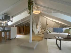 a living room with a couch and a table at L'isménia, Le Loft in Le Gosier