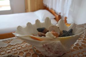 uma tigela branca com conchas em cima de uma mesa em Dimitra's Apartment em Votsi