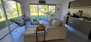 a living room with a couch and a table at Lamerced in Mar de Cobo