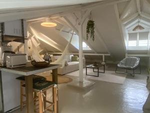 a living room with a table and a tent at L'isménia, Le Loft in Le Gosier