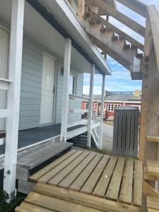 a porch of a house with a wooden deck at Ilulissat City Apartments- Apartment 2 in Ilulissat