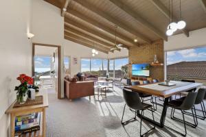a dining room and living room with a table and chairs at Seven Views in Clifton Springs
