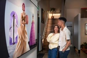 a man and a woman standing in front of a dress display at Hotel Indigo Melbourne on Flinders by IHG in Melbourne +132 photos