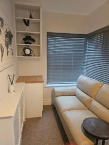 a living room with a couch and a table at Mini studio apartment in Tulla