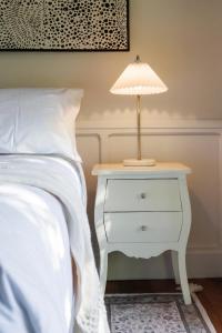a lamp on a night stand next to a bed at Misty Valley Cottage in Mapleton