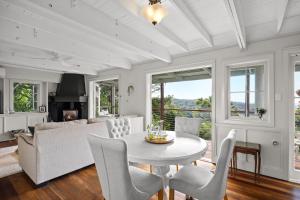a dining room with a table and chairs and a couch at Misty Valley Cottage in Mapleton +38 photos