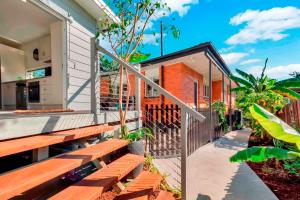a balcony of a house with wooden benches at Private Modern Bungalow - Separate Entry in Brisbane
