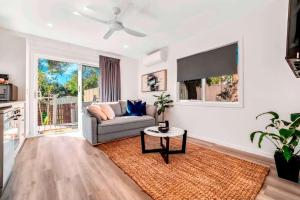a living room with a couch and a table at Private Modern Bungalow - Separate Entry in Brisbane