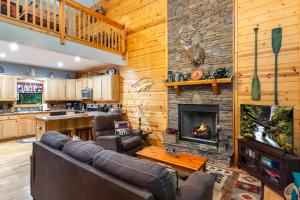 a living room with couches and a fireplace at Quiet mornings and golden hour views welcome to our woodland sanctuary Deer Watch Retreat in Ellijay