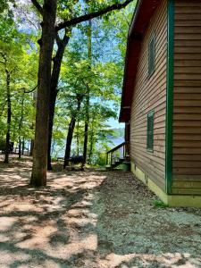a side of a house with a tree next to it at E-HOT SPRINGS MYSTIQUE - Historic Five Points Lake Hamilton in Hot Springs