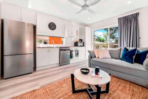 a living room with a couch and a table at Private Modern Bungalow - Separate Entry in Brisbane