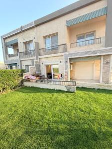an apartment building with a lawn in front of it at Coronado Marina in Ain Sokhna