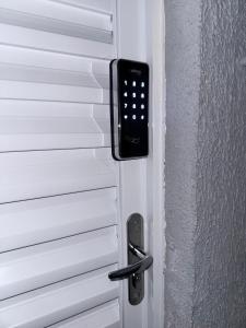 a door with a remote control attached to it at Casa Completa in Curitiba