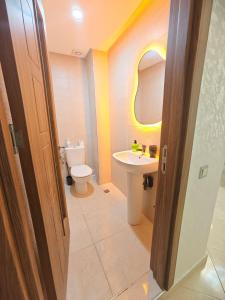 a bathroom with a white toilet and a sink at Ryad el houda in Agadir +35 photos