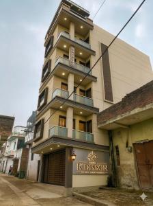 a tall building with a sign on it at Hotel KDISSON in Mohaniā