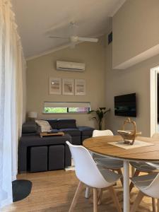 a living room with a table and a couch at Sea Renity Preston Beach in Preston Beach