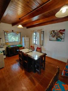 a kitchen with a table and chairs in a room at La Quebrada del Molle in San Marcos Sierras