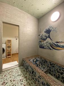 a room with a painting of a wave on the wall at 姫路城下町 巡 in Himeji +16 photos