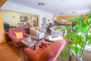een woonkamer met banken en stoelen en een tafel bij Alojamiento Soledad in Huaraz