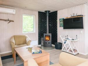 a living room with a wood stove in a room at 4 star holiday home in Ørsted-By Traum in Ørsted