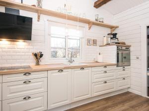 a kitchen with white cabinets and a sink at 4 star holiday home in Hemmet in Hemmet