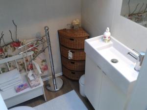 a bathroom with a toilet and a sink and a basket at Landhaus Bellecôte in Reit im Winkl +37 photos