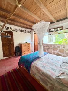 a bedroom with a large bed in a room at Intimunay Shala Yoga Center in Las Núñez