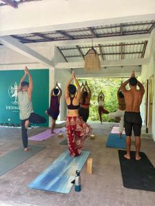 a group of people in a yoga class at Intimunay Shala Yoga Center in Las Núñez