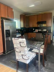 a kitchen with a table and chairs and a refrigerator at six bedroom house in Victoria