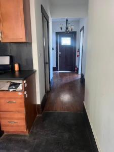 a hallway of a kitchen with a counter and a door at six bedroom house in Victoria +3 photos